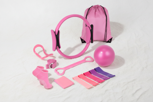 Minimalistic flat lay of 13-piece yoga and pilates set in pink